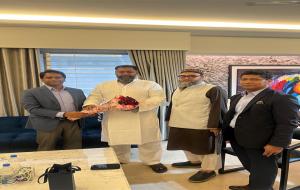 IOF officials greet the newly elected MP, M. Manjurul Karim Roni, with a bouquet.